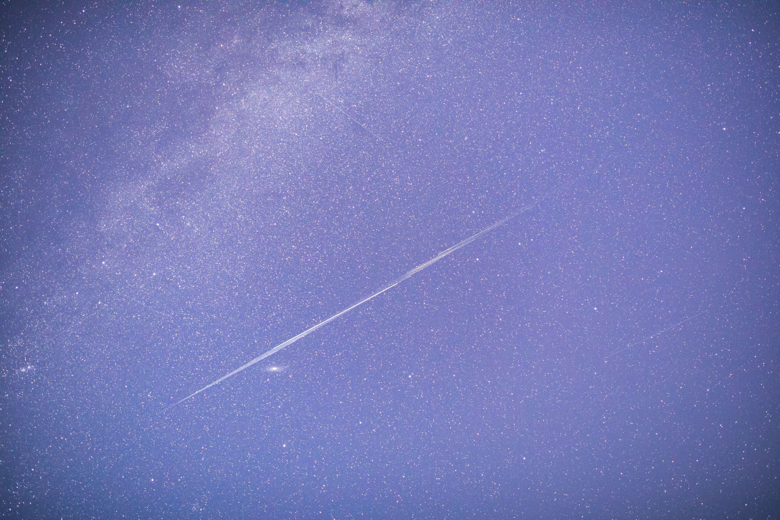 Starlink satellites streak through a photo of the night sky 