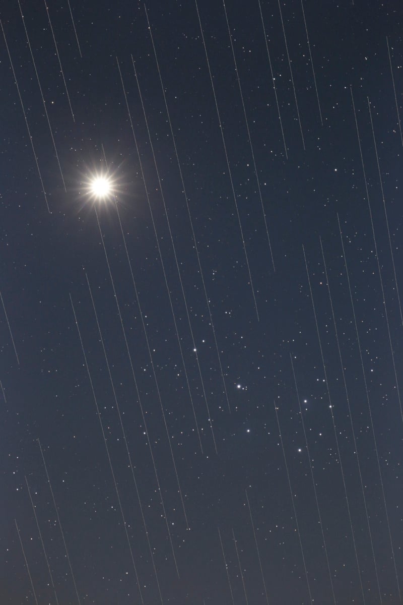 Megaconstellations streak through a photo of the night sky